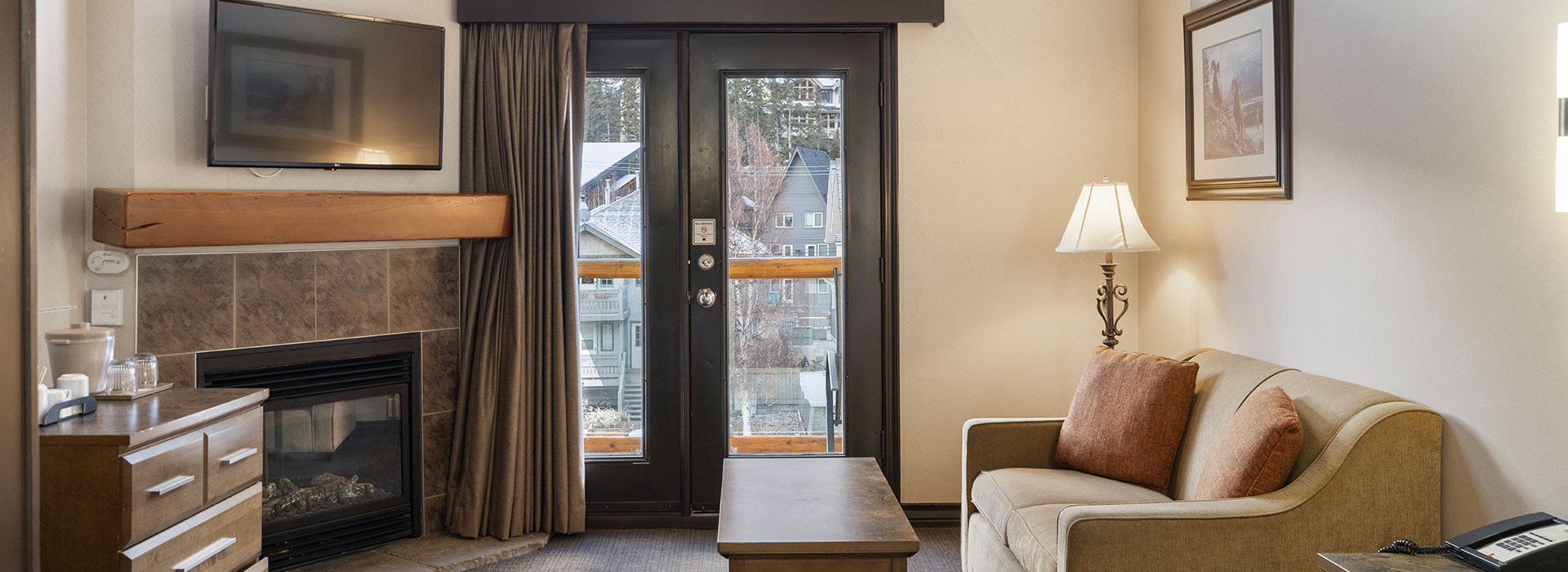 Hotel room with living area and fireplace